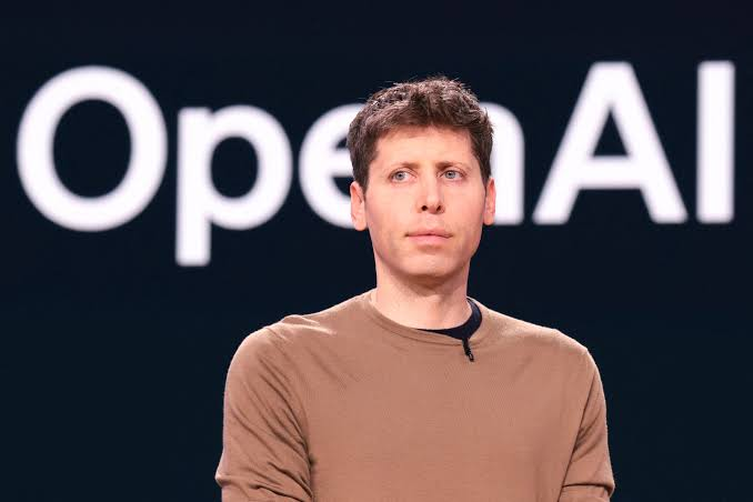 OpenAI chief executive Sam Altman in front of the OpenAI logo